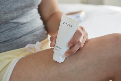 Person applying Sensica body gel to their leg